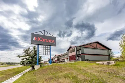 a sign for a k kaminica building on the side of a road at The Kanata by BCMInns - Hinton in Hinton