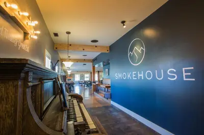 a lobby of a smoking house with a sign on the wall at Red Tree Lodge in Fernie