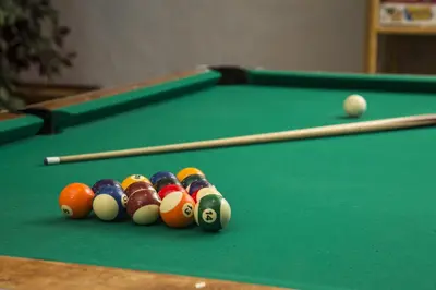 a group of billiard balls on a pool table at Red Tree Lodge in Fernie