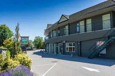 a building with a parking lot in front of it at Summerland Motel in Summerland