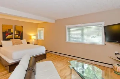 a bedroom with a bed and a couch and a tv at M Lofts in Calgary