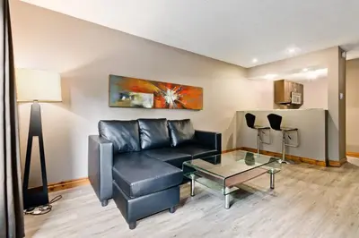 a living room with a black couch and a table at M Lofts in Calgary