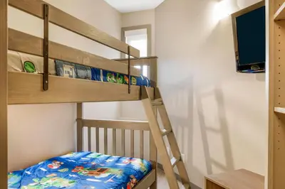 a bunk bed room with a ladder and a bunk bed at Days Inn & Suites by Wyndham West Edmonton in Edmonton