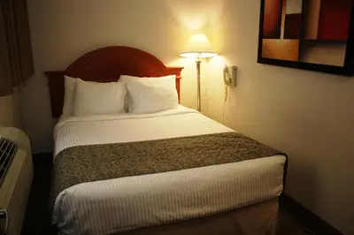 a bedroom with a bed in a hotel room at Ramada by Wyndham Edmonton South in Edmonton