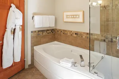 a bathroom with a tub and a glass shower at Long Beach Lodge Resort in Tofino