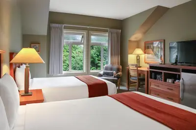 a hotel room with two beds and a window at Long Beach Lodge Resort in Tofino