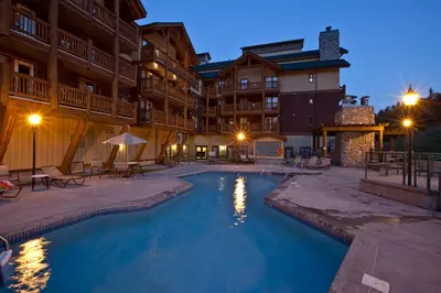 a swimming pool in the middle of a resort at night at Trickle Creek Lodge in Kimberley