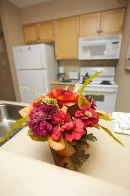 a bouquet of flowers sitting on a counter in a kitchen at Trickle Creek Lodge in Kimberley