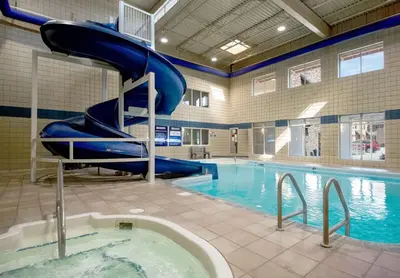 a swimming pool with a blue slide in a building at Coast Osoyoos Beach Hotel in Osoyoos