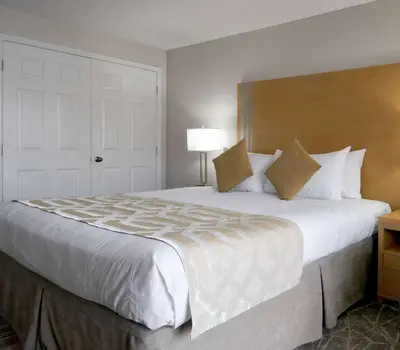 a large white bed in a hotel room at Coast Osoyoos Beach Hotel in Osoyoos
