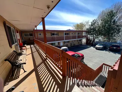a balcony of a building with a car in a parking lot at Sun Beach Motel in Osoyoos