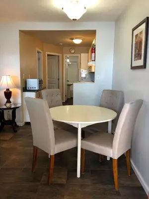 a dining room with a table and chairs at Sun Beach Motel in Osoyoos