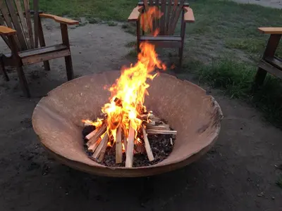 a fire pit in a yard with two chairs at Valemount Vacation Inn in Valemount