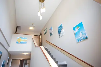 a staircase with pictures on the walls of a house at Valemount Vacation Inn in Valemount
