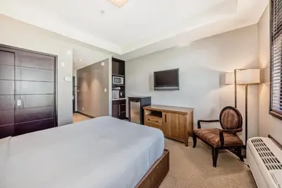 a hotel room with a bed and a desk at Copper Point Resort in Invermere