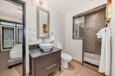 a bathroom with a sink and a toilet and a shower at Copper Point Resort in Invermere