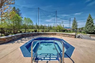 a large swimming pool with a volleyball net at Copper Point Resort in Invermere