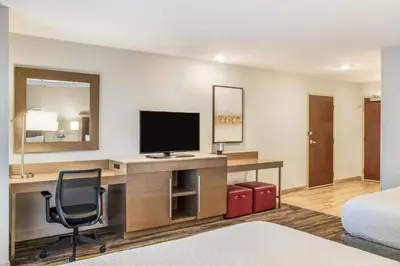 a hotel room with a desk with a television at Ramada by Wyndham St Paul AB in St. Paul