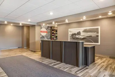 a lobby with a bar with a picture on the wall at Ramada by Wyndham St Paul AB in St. Paul