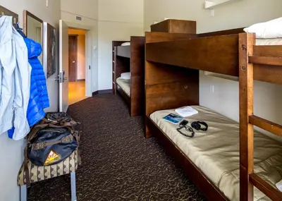 a room with two bunk beds and a hallway at HI Whistler - Hostel in Whistler
