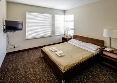 a bedroom with a bed with two towels on it at HI Whistler - Hostel in Whistler