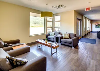 a living room with couches and a table at HI Whistler - Hostel in Whistler