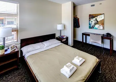 a bedroom with a bed with two towels on it at HI Whistler - Hostel in Whistler