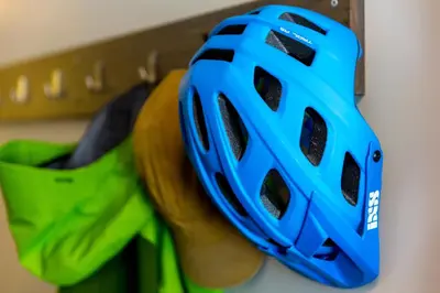a blue bike helmet hanging on a wall at HI Whistler - Hostel in Whistler