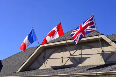 three flags on the roof of a house at The Hospitality Inn in Port Alberni