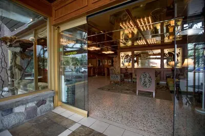 a store front with glass windows and a dining room at Crest Hotel in Prince Rupert