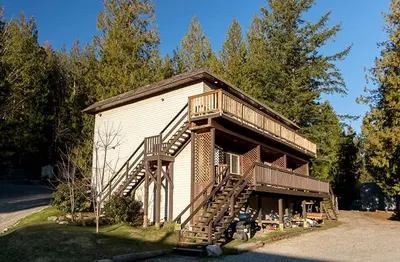 a house with a staircase on the side of it at Backeddy Resort and Marina in Egmont