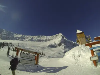 a man standing at the top of a snow covered mountain at Fernie Slopeside Lodge in Fernie