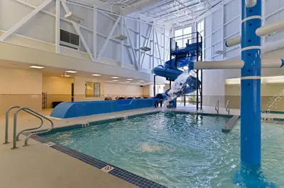 a large indoor pool with a water slide at Siding 16 Lodge in Wetaskiwin