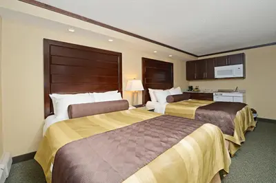 a hotel room with two beds and a kitchen at Siding 16 Lodge in Wetaskiwin