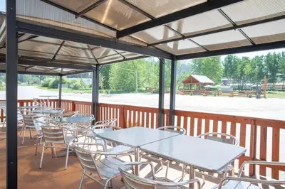 a group of tables and chairs on a deck at Travelodge by Wyndham Golden Sportsman Lodge in Golden