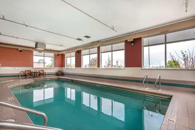a swimming pool in a building with windows at Best Western Strathmore Inn in Strathmore