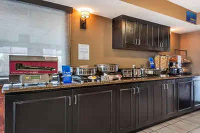 a kitchen with a counter top with pots and pans at Best Western Strathmore Inn in Strathmore