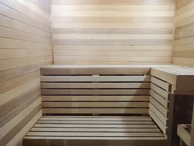 a sauna with wood paneling and a bench in it at Days Inn by Wyndham Valemount in Valemount