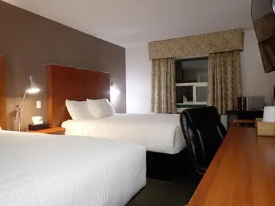 a hotel room with two beds and a window at Days Inn by Wyndham Valemount in Valemount
