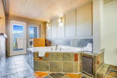 a large bathroom with a tub with a window at Days Inn by Wyndham Golden in Golden