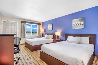 a hotel room with two beds and a window at Days Inn by Wyndham Golden in Golden
