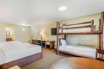 a hotel room with two bunk beds and a table at Days Inn by Wyndham Golden in Golden
