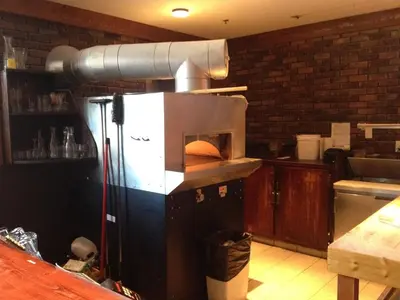 a kitchen with a microwave oven in a kitchen at Howe Sound Inn & Brewing Company in Squamish