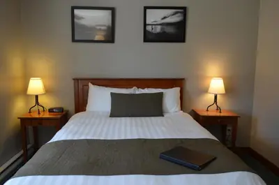 a bedroom with a bed with a book on it at Howe Sound Inn & Brewing Company in Squamish