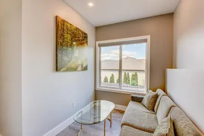 a living room with a couch and a window at Adela's Bed and Breakfast in West Kelowna