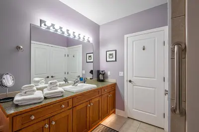 a bathroom with a sink and a mirror at Adela's Bed and Breakfast in West Kelowna
