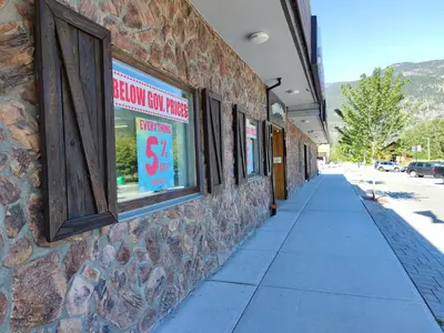 a brick building with a sign in a store window at Pemberton Hotel (Motel) in Pemberton