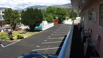 a balcony of a building with a view of a parking lot at Swiss Sunset Inn in Penticton