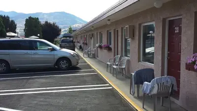 a car parked on a street next to a building at Swiss Sunset Inn in Penticton