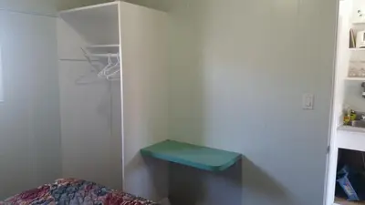 a room with a blue stool in the corner of a room at Holiday House Motel in Penticton
